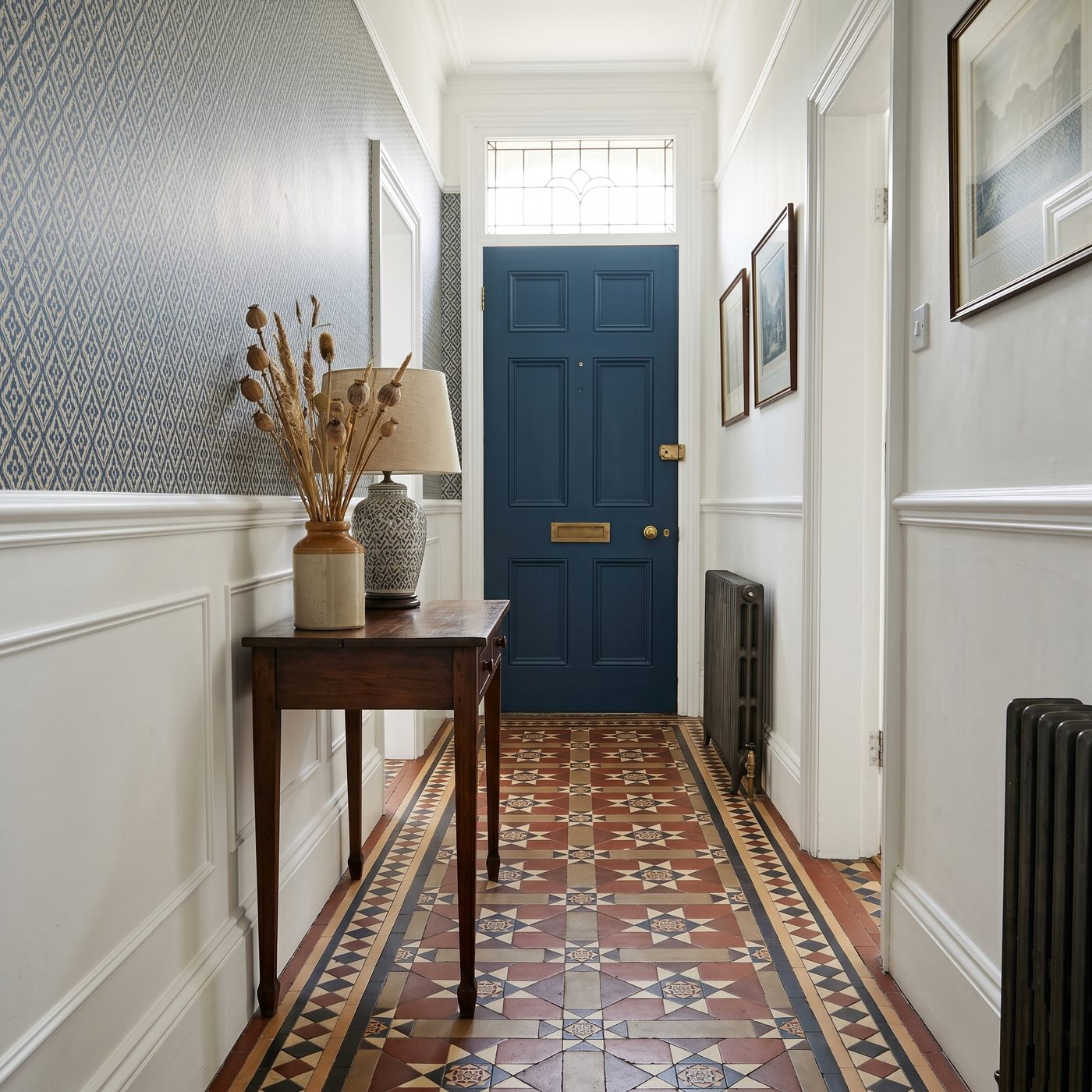 Victorian hallway with freshly decorated woodwork and traditional encaustic tile floor