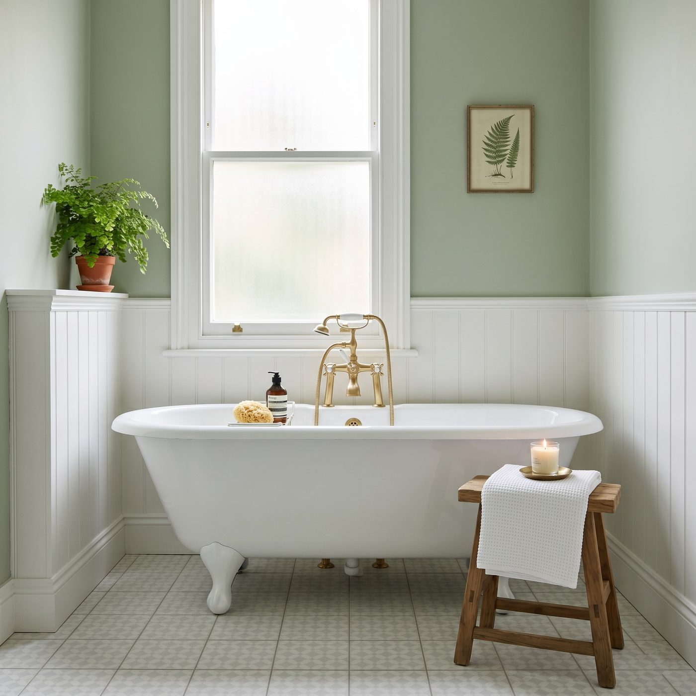 Classic British bathroom freshly painted in heritage sage green with white tongue and groove panelling